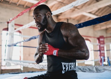 Man boxing while wearing Everlast clothing and gloves
